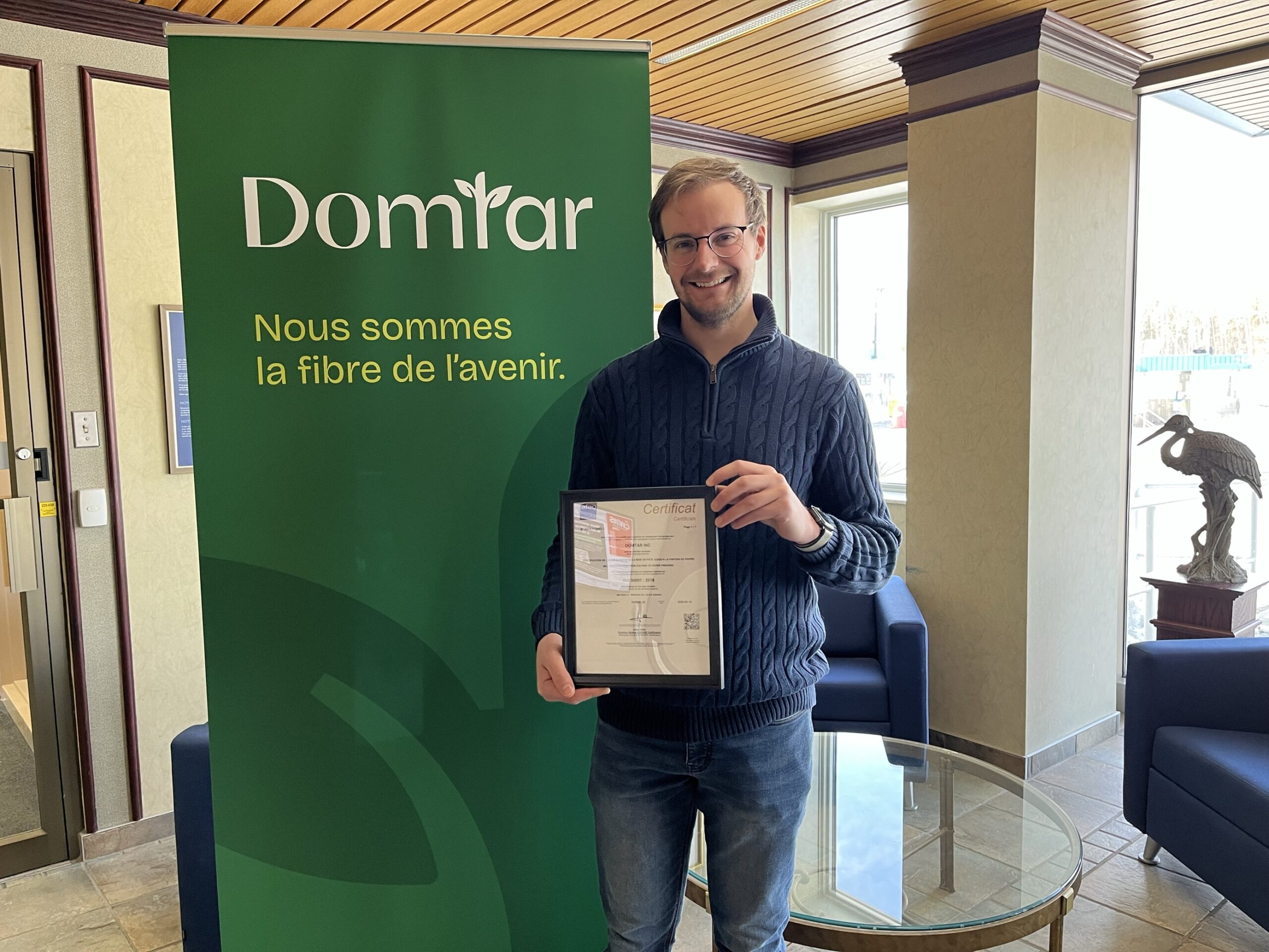 Jeffrey Byrns, process engineer at Windsor Mill, holds the mill's new ISO 50001 certificate. The Windsor Mill certification is a testament to Domtar’s long-term environmental commitment.